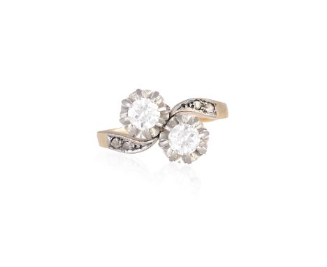 A DIAMOND CROSS-OVER RINGThe two brilliant-cut diamonds between rose-cut diamond shoulders, mounted in 18K gold, diamonds app