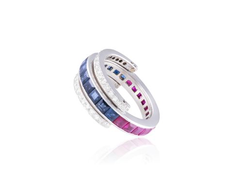 A SAPPHIRE AND RUBY RING WITH REVERSO DIAMOND BORDERThe continuous row of square-cut sapphires giving way to a continuous row