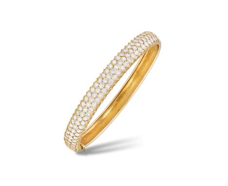 A DIAMOND BANGLEThe hinged bangle set to the front with three rows of round brilliant-cut diamonds, mounted in gold, diamonds