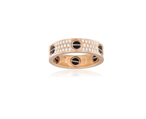 A GENTLEMAN'S DIAMOND AND BLACK CERAMIC 'LOVE' RING, BY CARTIERDecorated with black ceramic screwhead motifs and pavé-set thr