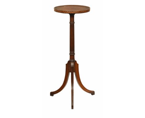A late 19th/early 20th century mahogany plant stand, with Greek key inlay to the side, raised on a reeded stem and three reed