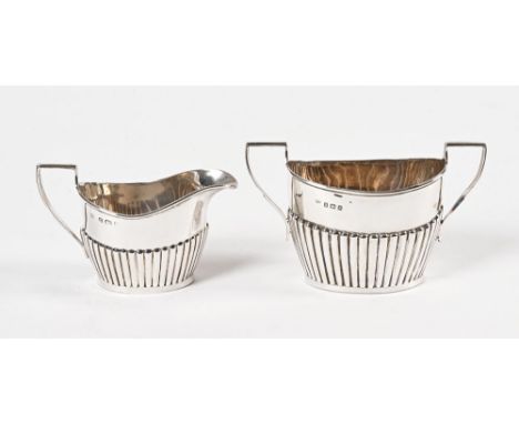 An Edwardian silver milk jug and sugar basin, both by William Aitken Birmingham, the sugar marked 1909 and the milk 1913.  Si