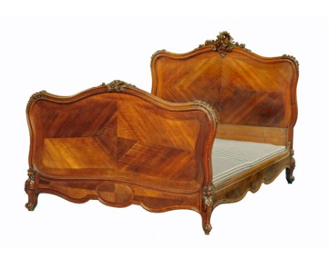 A French double bed, with carved moulded frame complete with mattress base. Base dimensions 130 cm x 186 cm, headboard height