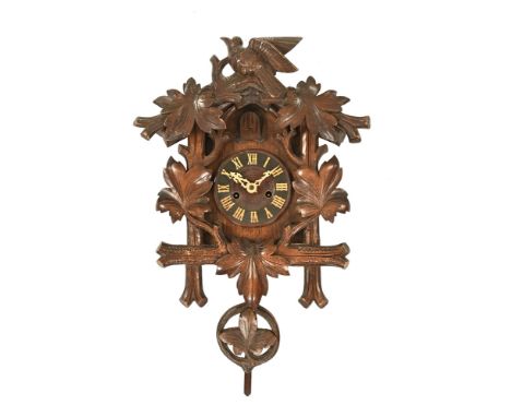 A Black Forest cuckoo clock, with two train striking movement. Height 40 cm, width 35 cm (see illustration). The clock in our
