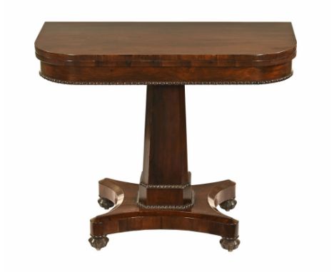 A William IV rosewood turnover top card table, with green baize lined interior with rounded corners faceted columns and quatr