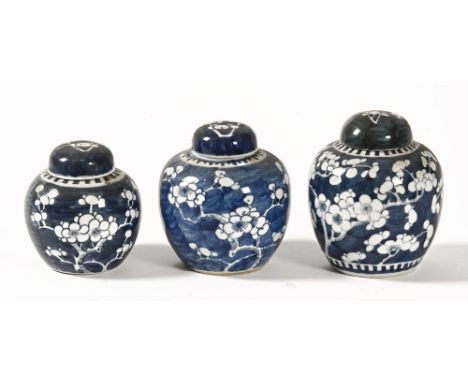 Three ginger jars, decorated with blossom, the largest with four character mark to the base, the medium with two blue circles