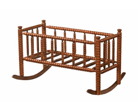 An American bobbin turned rocking cradle.  Height 62 cm, length 101 cm, maximum width at rocker 75 cm.