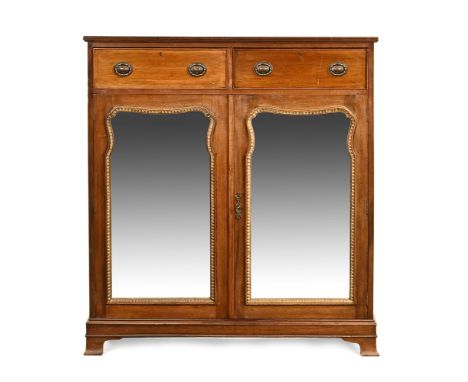 A continental mahogany cupboard, with two short drawers to the top section with brass handles with pair of mirrored doors ben