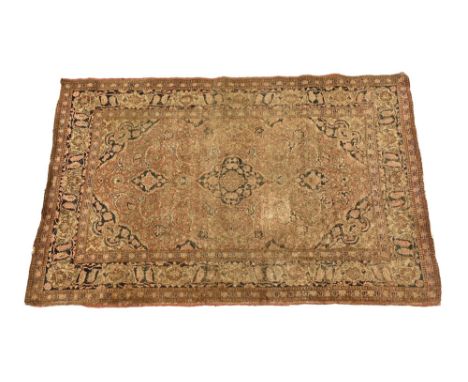 An antique Persian rug, the border decorated with blues and red and having a central foliate patterned panel.  204 x 135 cm.