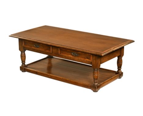 In the manner of Titchmarsh &amp; Goodwin, an oak crossbanded rectangular coffee table, with two drawers to one side. Height 