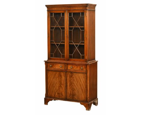 A 20th century mahogany display cabinet, with dentil cornice and astragal glazed doors with two adjustable shelves, the base 