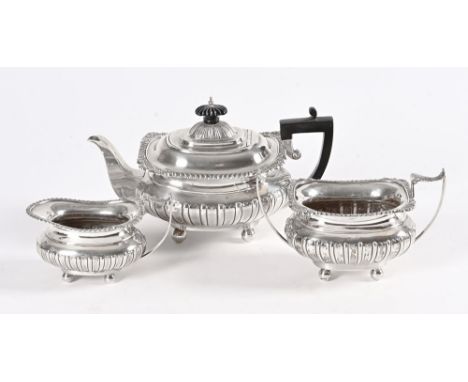 A three piece Sheffield silver tea service, 1908 James Deacon &amp; Sons, comprising teapot with ebonised handle and finial. 