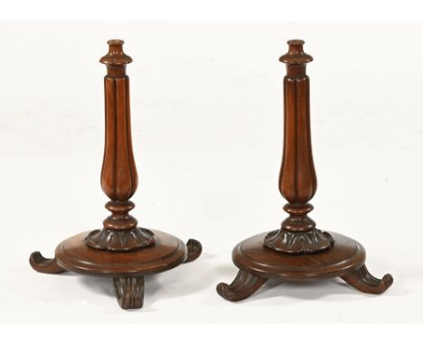 A pair of Victorian rosewood pole screen bases, each with lobe support circular base and three downswept scroll feet.  Height