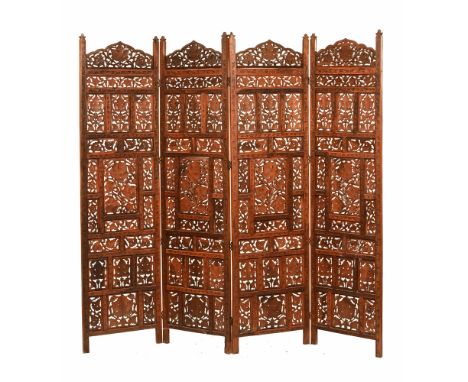 An Indian four section carved wooden screen, each panel measuring 181 cm, width 50 cm.