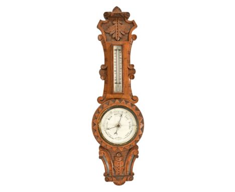 An oak cased aneroid barometer, with mercury thermometer.  Height 63 cm.