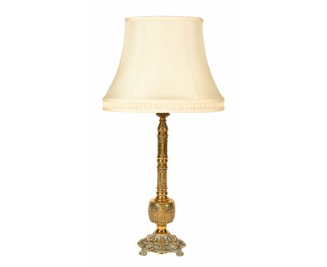 A brass oriental table lamp, with cream shade.&nbsp; Height excluding light fitting 58 cm.
