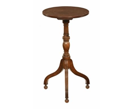 A Georgian mahogany tripod table, with circular top turned stem and raised on three reeded legs terminating in wooden ball fe