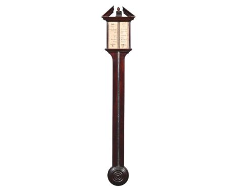 A George III mahogany stick barometer, with triangular pediment and paper label marked summer and winter and with turned cist