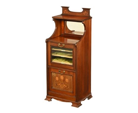 An Edwardian mahogany music cabinet, with rear upstand with shelf and mirrored section above a glazed cupboard door with gree