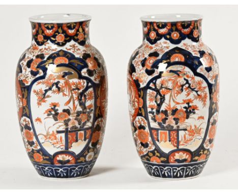 A pair of 19th century Imari vases, decorated in typical Imari colours with chrysanthemum and repeating butterfly and foliate