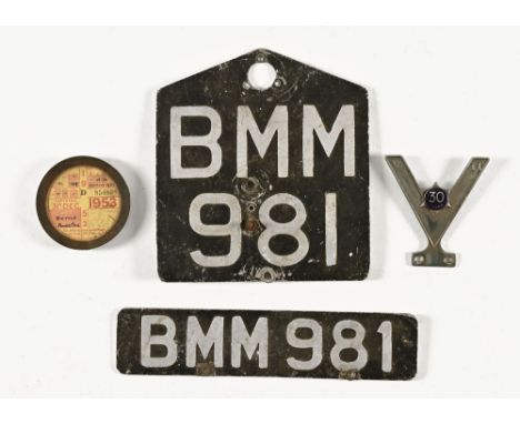 A pair of vintage motorcycle number plates, a tax disc holder and a veteran motorists 30 Year car or motocycle badge.