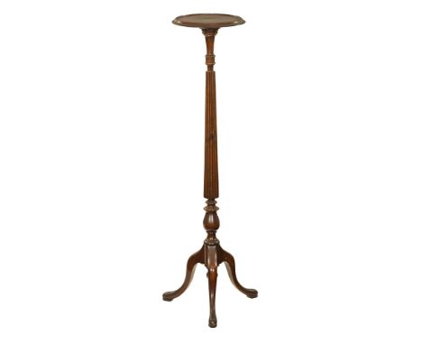 A mahogany torchere, with moulded edge fluted column and three downswept legs terminating in pad feet.  Height 123 cm, top di