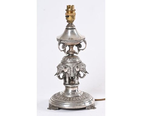 An Anglo Indian silver plated table lamp base, in the form of elephants raised on a circular base. Height to top of light fit