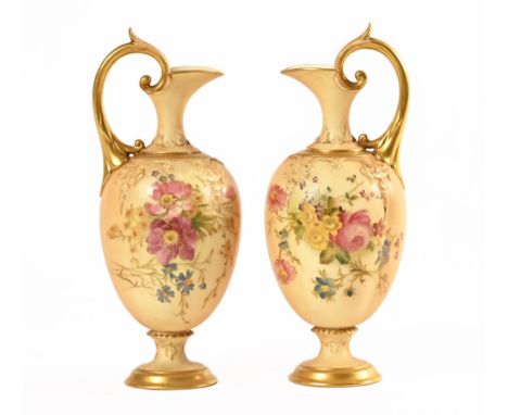 A pair of Royal Worcester foliate patterned blush ewers, each with puce printed mark. Height 20 cm.On one of the sconces the 