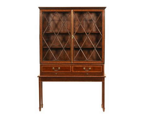 A 19th century mahogany inlaid bookcase on stand, with diamond patterned glazed doors and two internal shelves the base secti