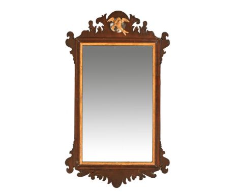 A George III mahogany fretwork wall mirror, with Ho Ho bird mount and gilt slip. Height 76 cm, width 45 cm.There is a crack t