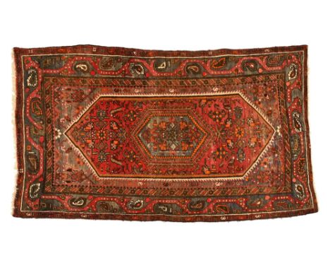 A Persian Hamadan style rectangular rug, with red ground and triangular decoration to the centre.&nbsp; 199 x 131 cm.