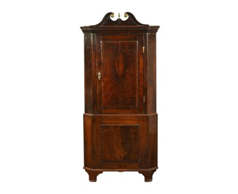 A George III oak and banded standing corner cupboard, in one section with swans neck pediment above the panelled door opening