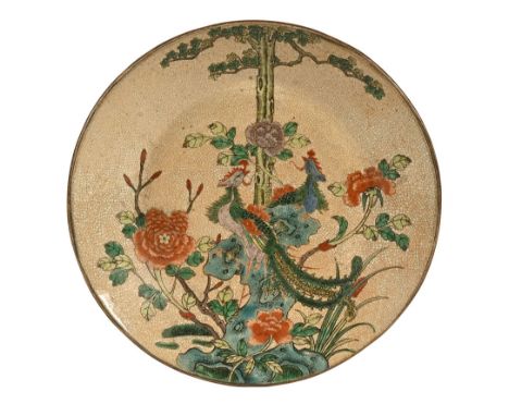 A Chinese crackle glaze charger, with peacock and tree decoration with Chinese character mark to the base. Diameter 36 cm.Thi