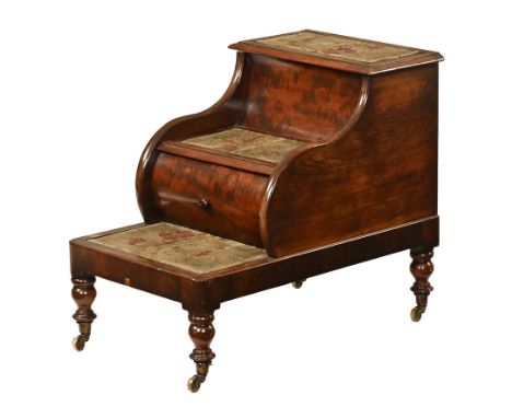 A Victorian mahogany three tier bed step commode, raised on turned legs terminating in castors.  Height 64 cm, width 47 cm, d