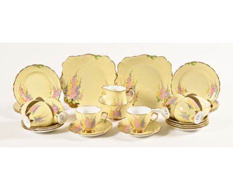 A Royal Standard tea set, comprising 10 cups, 9 saucers, 7 small plates, 2 sandwich plates, sugar basin and milk jug.
