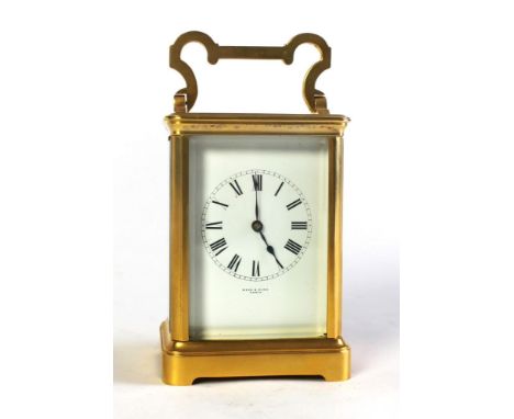 An Edwardian brass carriage clock by Reid &amp; Sons Paris, two train striking on a gong. Height excluding carrying handle 13