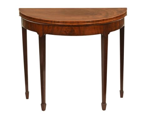 A George III mahogany CWJwood strung demi lune turnover top card table, with recessed frieze and raised on tapered legs of sq