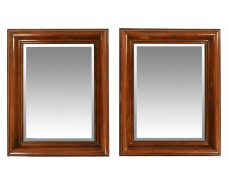 A pair of early 20th century mahogany rectangular mirrors, with bevelled glass.  Frame size 75 x 59 cm.The first mirror is in