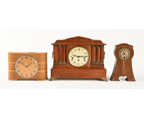 An Art Deco wooden cased money CWJ clock, "Two Florins Weekly", a walnut cased mantel clock and an Art Nouveau mantel clock.