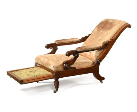 A 19th century library or reclining easy chair, with brass fittings and pullout leg support, upholstered in beige leather. He