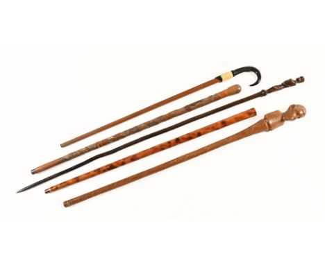 An African hardwood staff, figural. Height 121 cm, together with a horn handled stick, an oriental carved bamboo walking stic