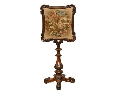 A Victorian mahogany pole screen, with woolwork tapestry panel, with well carved and turned support beneath raised on scroll 