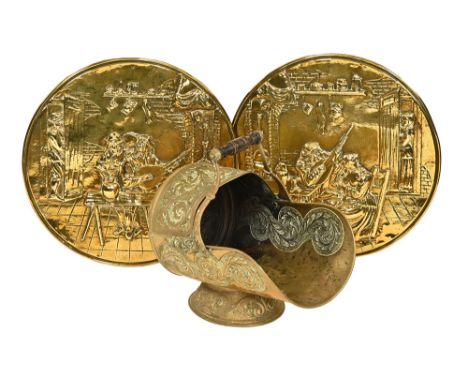 A Victorian brass embossed coal helmet, with floral design and turned wooden handle, the front stamped with a registered desi