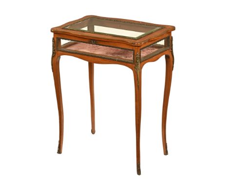 An early 20th century inlaid bijouterie table, with bevelled glass lid opening to a pink baize lined interior with four glaze