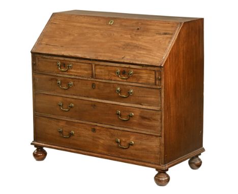 A Georgian mahogany bureau, with brass lock escutcheon and opening to a green baize lined shelf with fitted interior with two