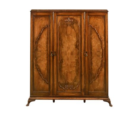 An Art Deco triple wardrobe, with brass handles and large hanging section to the left and centre, the right-hand fitted with 
