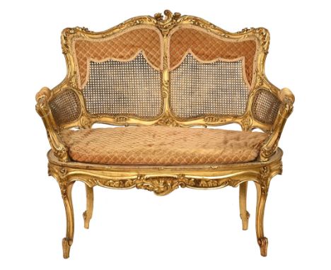 An Edwardian giltwood and bergere ladies boudoir settee, with bergere panel with exposed foliate carved and scrolling showfra