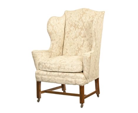 A Queen Anne style wing easy chair, with deep buttoned back outswept arms and loose cushion upholstered in beige foliate patt