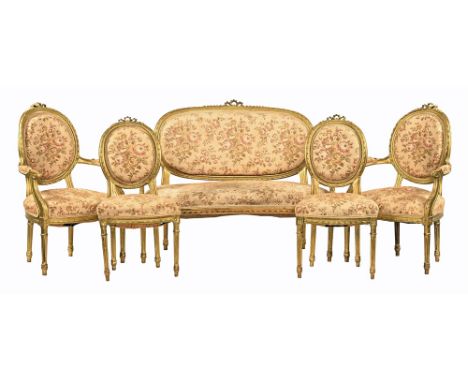 A late 19th/early 20th century gilt salon suite, comprising settee two armchairs and two single chairs, upholstered in a flor