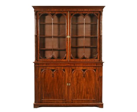 A Regency mahogany cabinet bookcase, with detachable moulded cornice above a pair of glazed doors with wooden astragals openi